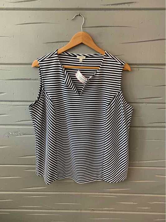 Sleeveless black and white striped blouse with V-neck on wooden hanger.