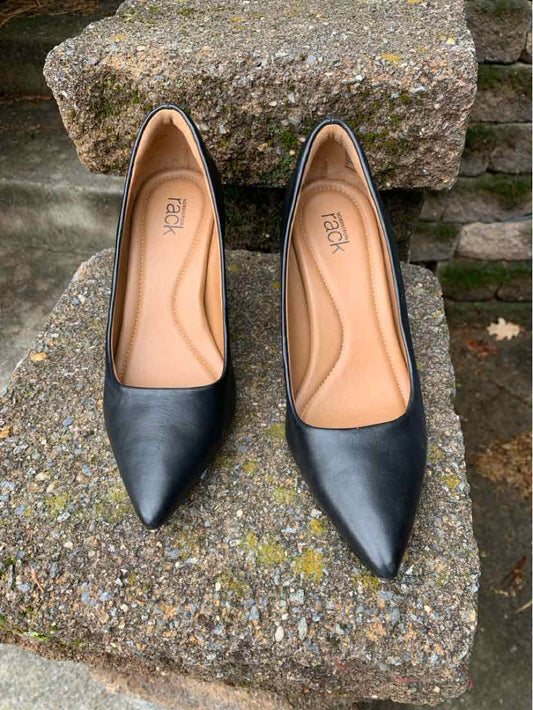 Black pointed-toe women's flats with smooth leather upper and tan cushioned insoles, size 6.