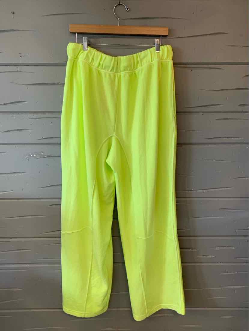 Neon yellow wide-leg pants with elastic waistband and smooth lightweight fabric.