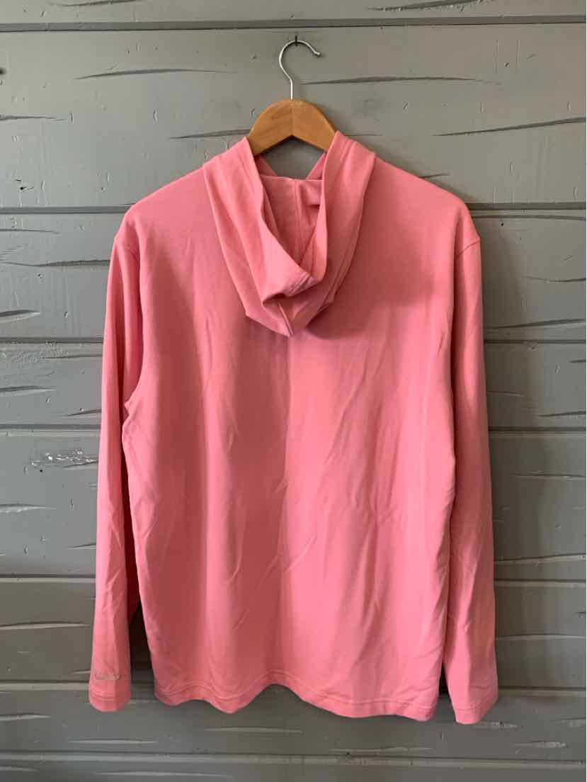 Long-sleeve solid pink high-neck polo shirt with smooth fabric hanging on wooden hanger.