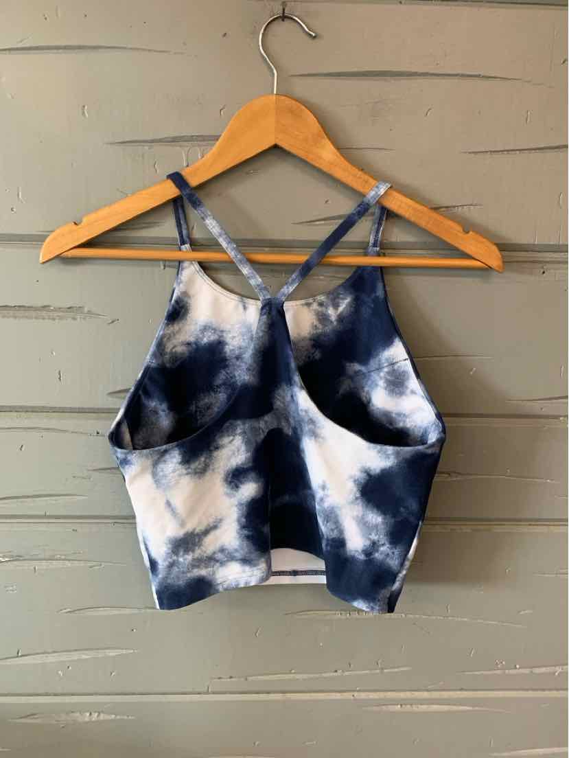 Women's navy and white tie-dyed cropped active tank top with thin crisscross straps.