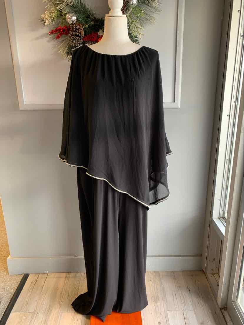 Black loose-fit long dress with sheer asymmetrical overlay and round neckline on mannequin.