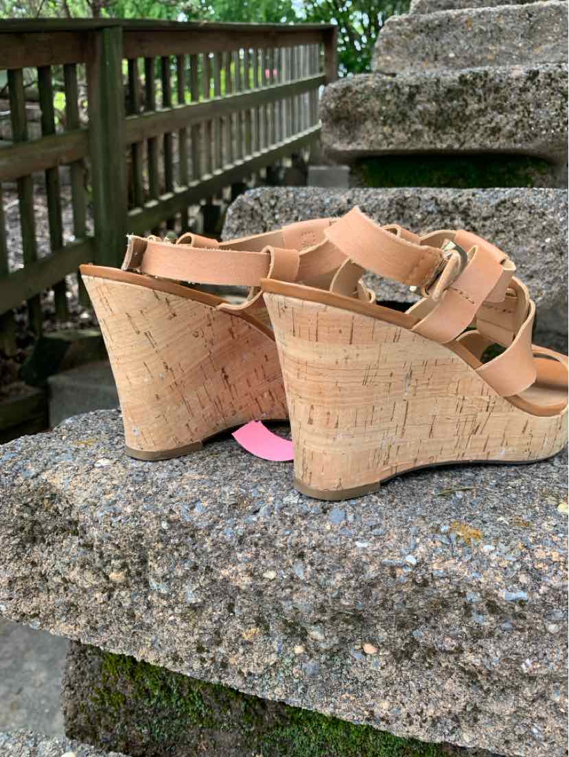 Tan wedge sandals with cork platform heels and adjustable straps in size 7.5.