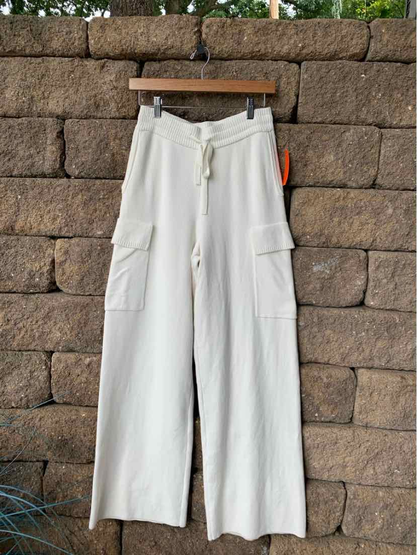 White wide-leg knit pants with drawstring waist and side cargo pockets.