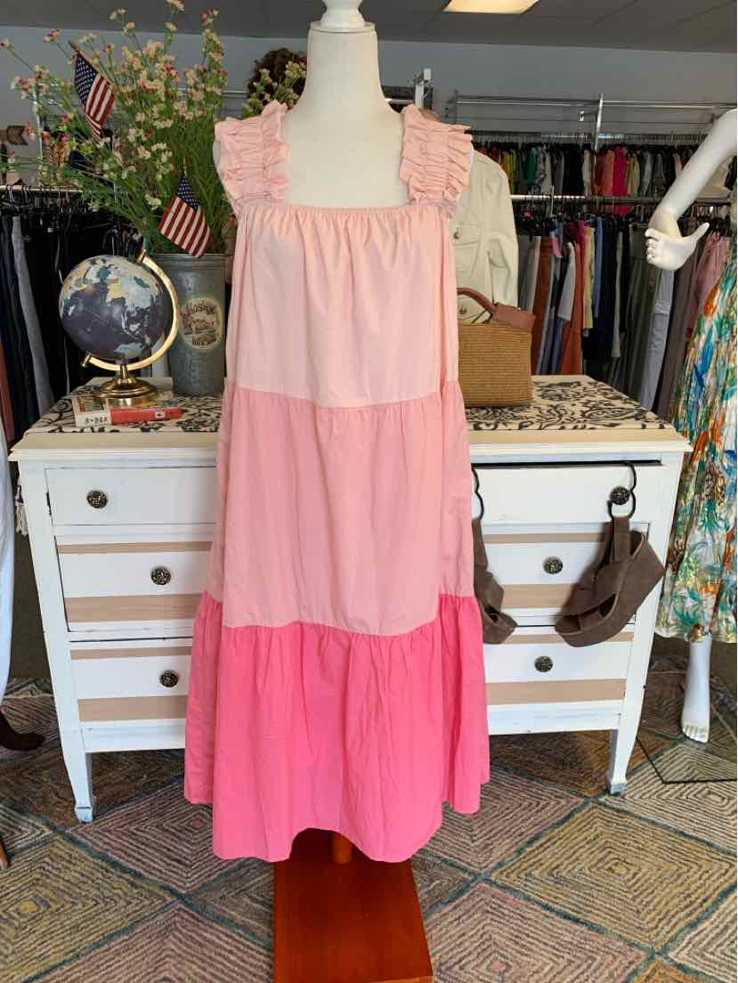 Sleeveless tiered dress in three shades of pink with ruffled square neckline and loose fit.