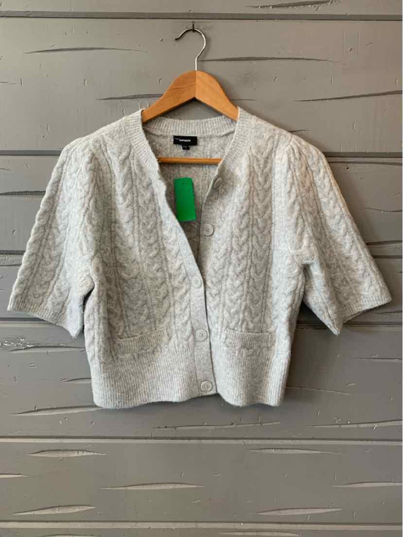 Light gray cable knit cropped cardigan with short sleeves and V-neck collar.