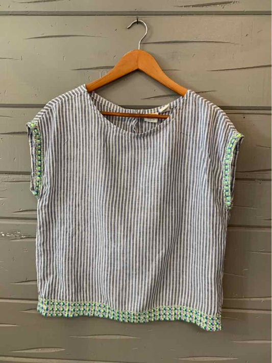 Short-sleeve women's blouse with vertical blue and white stripes and green embroidered trim on cuffs and hem.