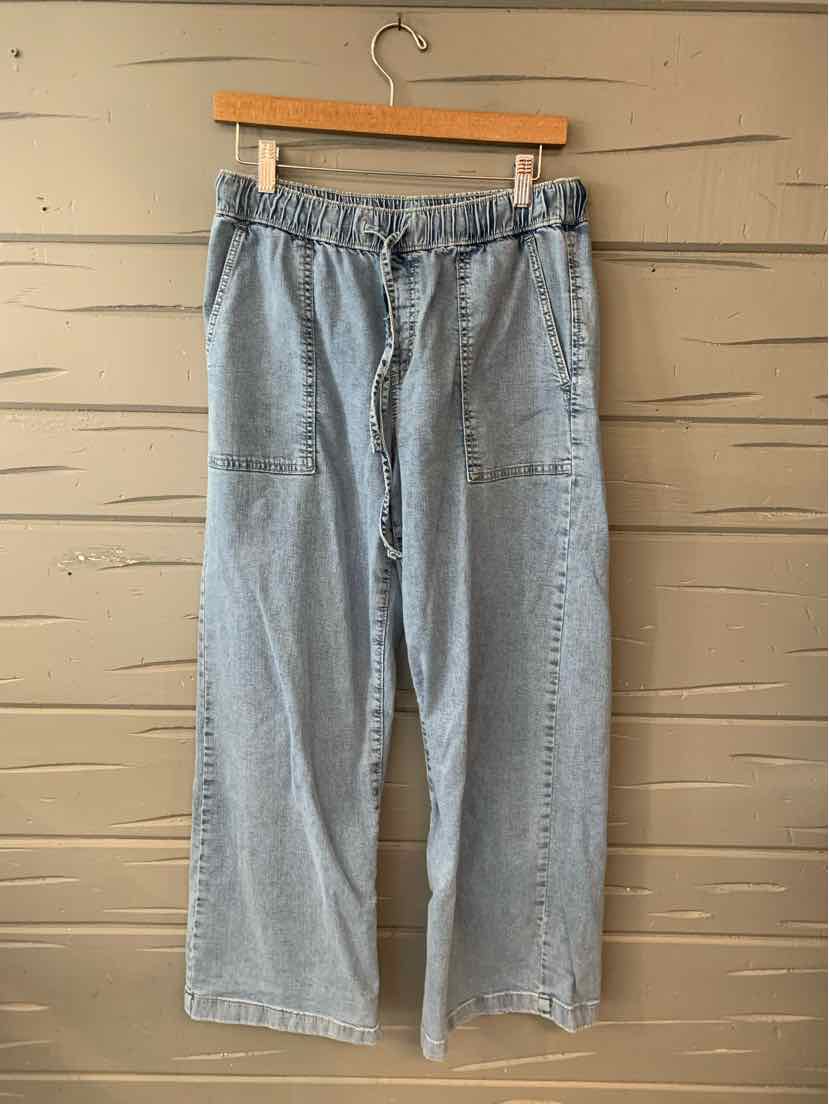 Light blue denim wide-leg pants with elastic waistband and front patch pockets.