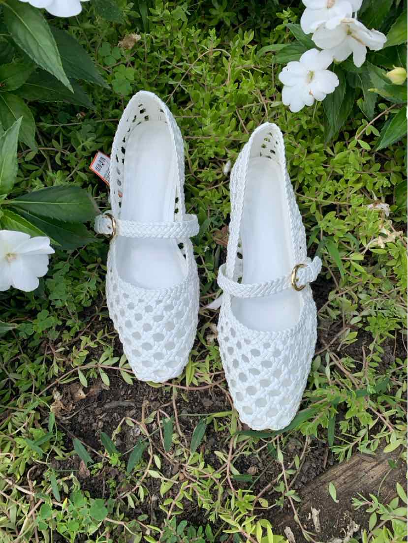 White women's ballet flats with perforated pattern, square toe, and ankle strap buckle closure.
