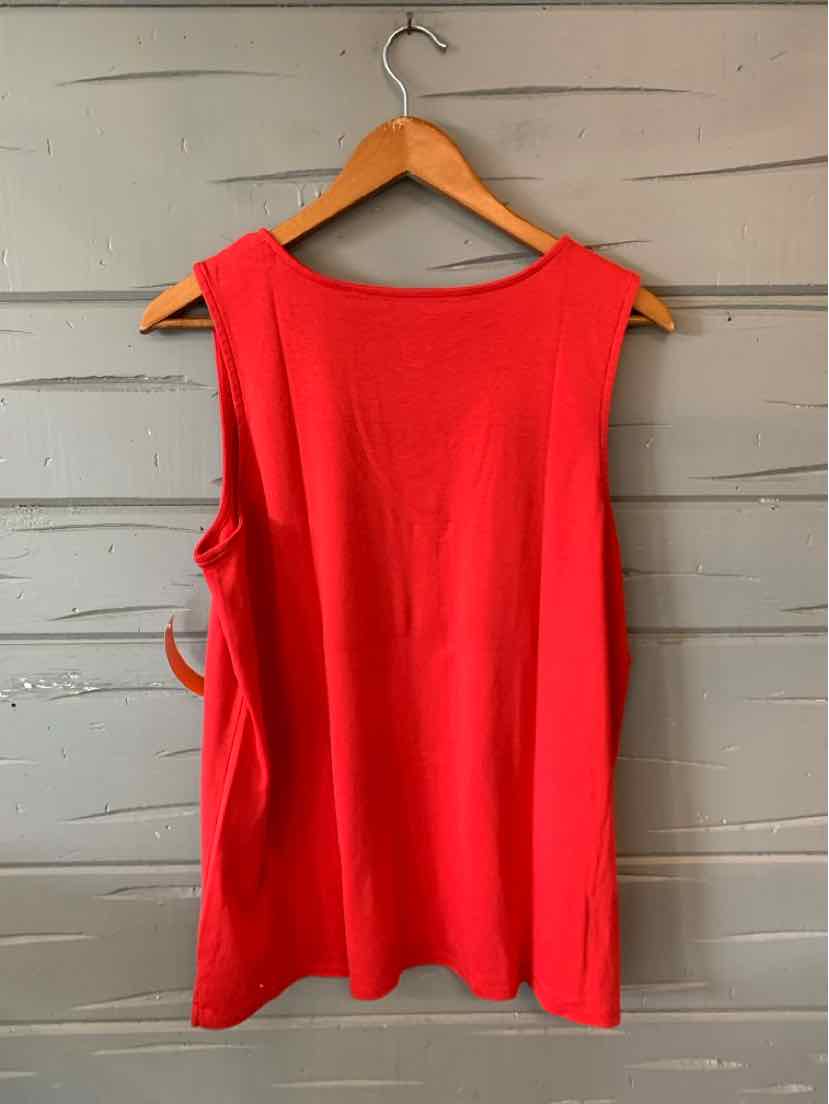 Bright red sleeveless top with wide shoulder straps and a straight hem on a wooden hanger.
