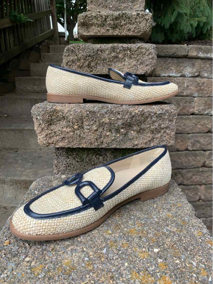 Beige woven slip-on shoes with navy blue trim and decorative buckle, flat sole, size 9.5.