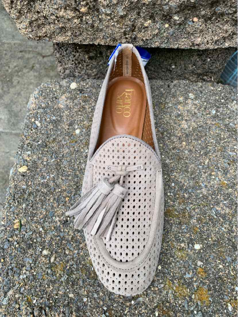 Beige suede loafer with perforated details and tassel accent, size 7.