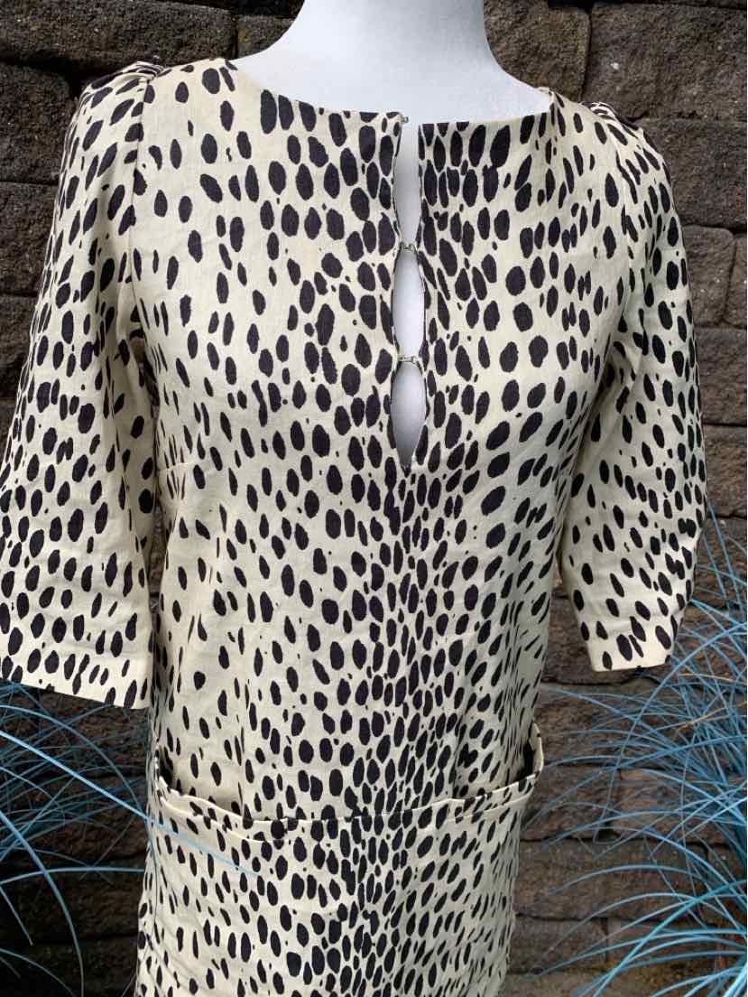 Cream blouse with black irregular dot animal print, keyhole neckline, and 3/4 sleeves.