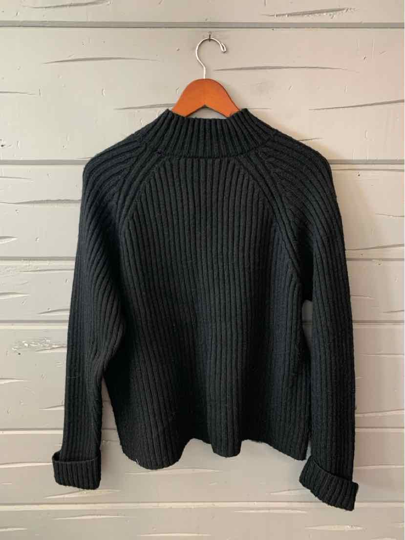 Black ribbed knit women’s sweater with a high mock neck, long sleeves, and a relaxed fit.