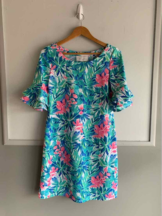 Teal floral dress with pink and green leaf print, short ruffled sleeves, and a relaxed fit.