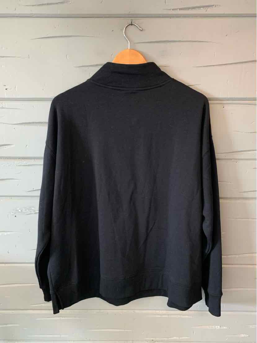 Black long-sleeve knit top with a mock neck collar, size XL, hanging on wooden hanger.