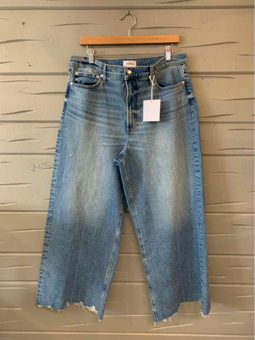 Light blue high-waist denim jeans with frayed wide-leg hems and classic five-pocket design.