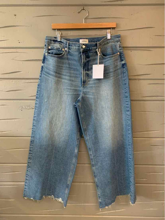 Light blue high-waist denim jeans with frayed wide-leg hems and classic five-pocket design.