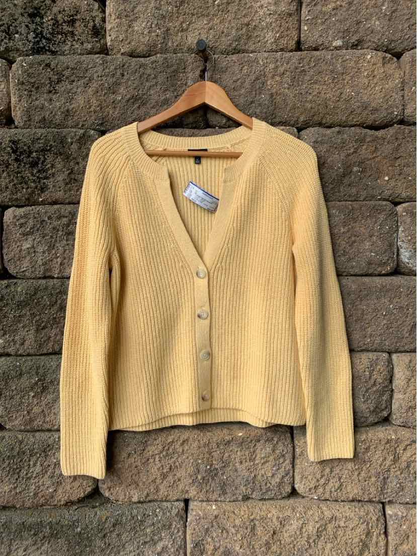 Mustard yellow knit cardigan with a crew neckline, front buttons, and long sleeves.