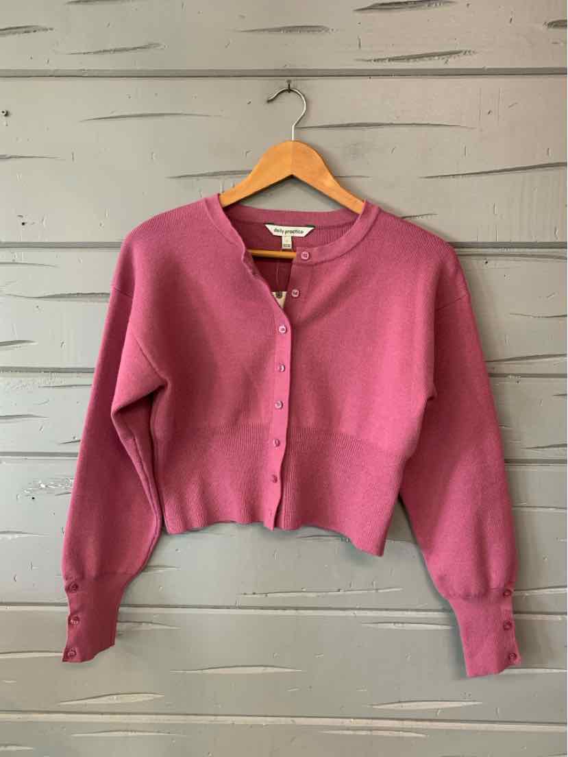 Pink cropped knit cardigan with a round neckline, button front, long sleeves, and ribbed trim.