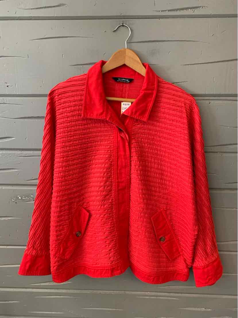 Red textured zip-up jacket with collar, long sleeves, and front pockets on wooden hanger.