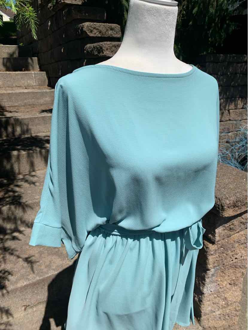 Teal short-sleeve dress with cinched waist and round neckline in lightweight fabric.