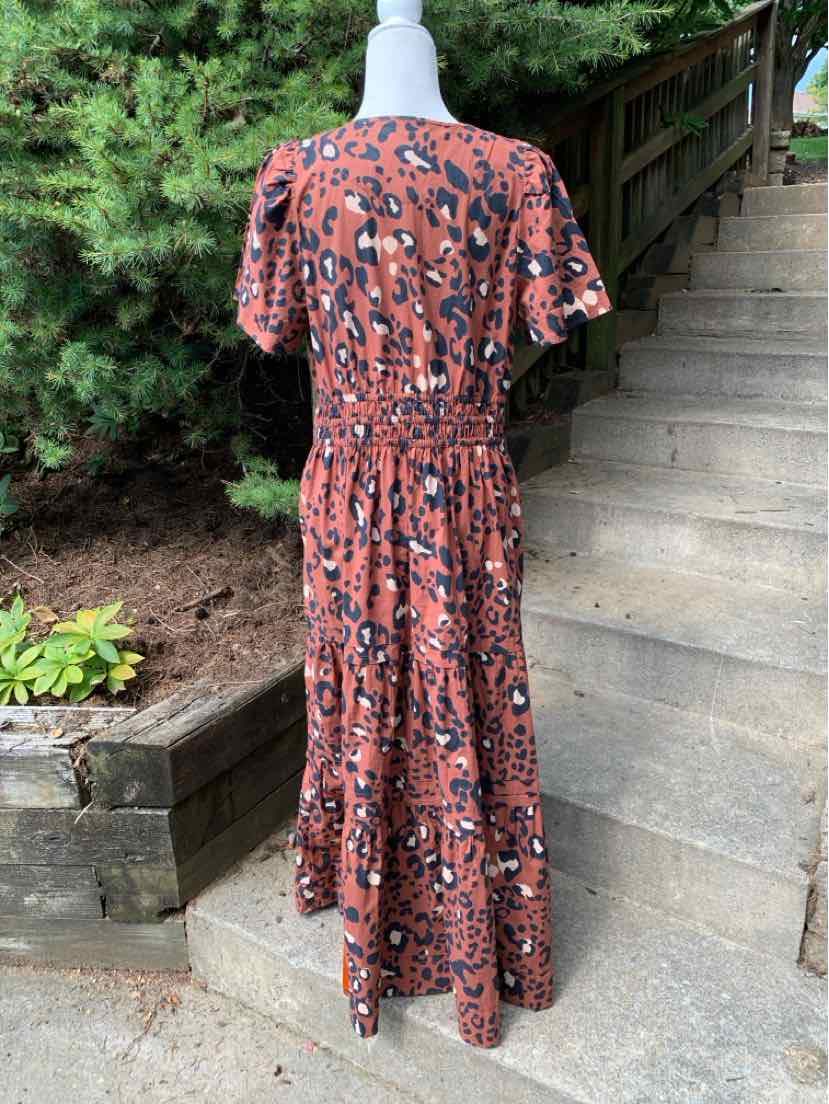 Brown cheetah print midi dress with short sleeves and gathered waist, flowy skirt silhouette.