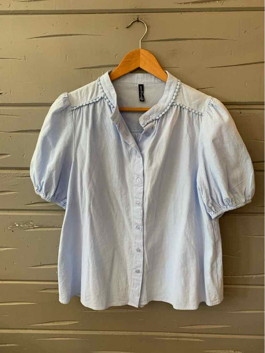 Light blue blouse with puffed short sleeves, ruffled collar, and button-down front in medium size.