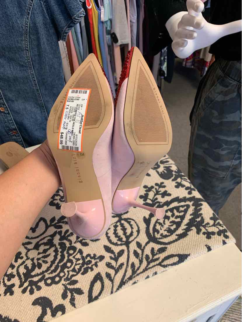 Pair of pink pointed-toe high heels in size 7.5 with smooth finish and beige soles.