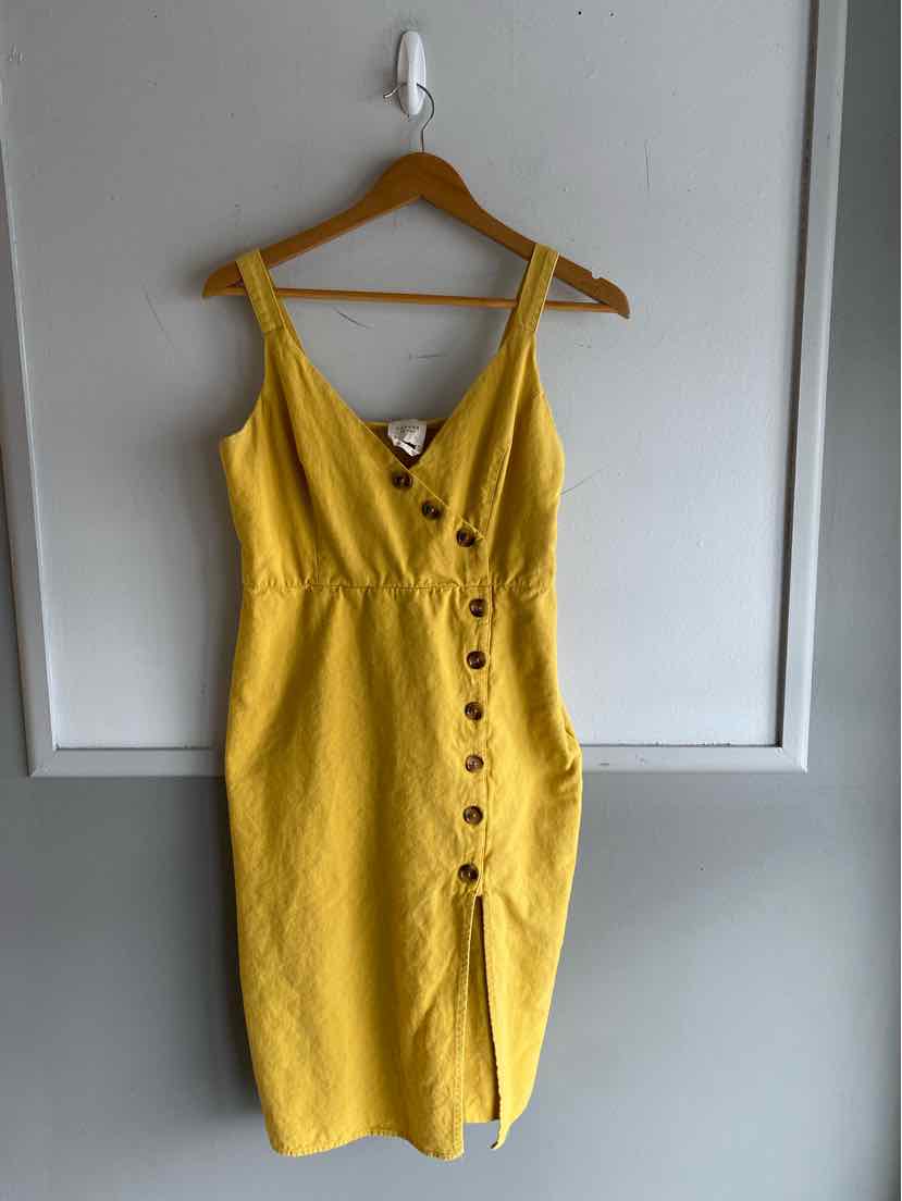 Yellow sleeveless button-front dress with V-neck and fitted waist, midi length.