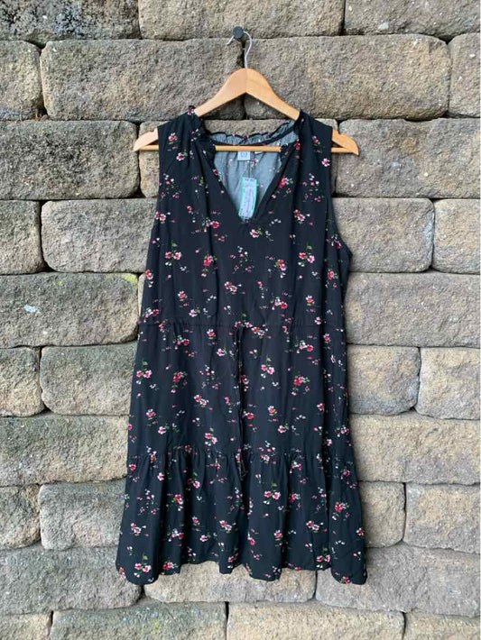 Black sleeveless dress with small red floral print and ruffled hem, size large.