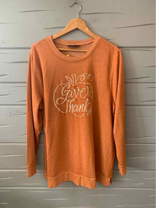 Long-sleeve orange crewneck sweatshirt with "Give Thanks" white script and leaf design on front.