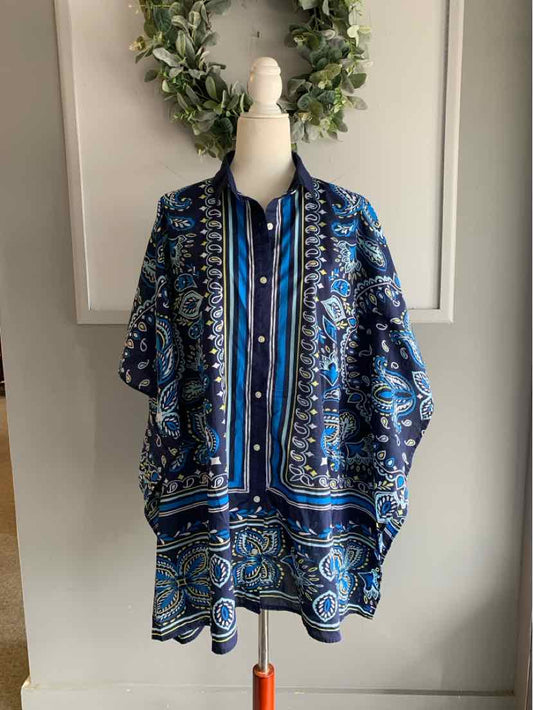 Blue paisley patterned women's tunic with button-down front and loose fit on mannequin.