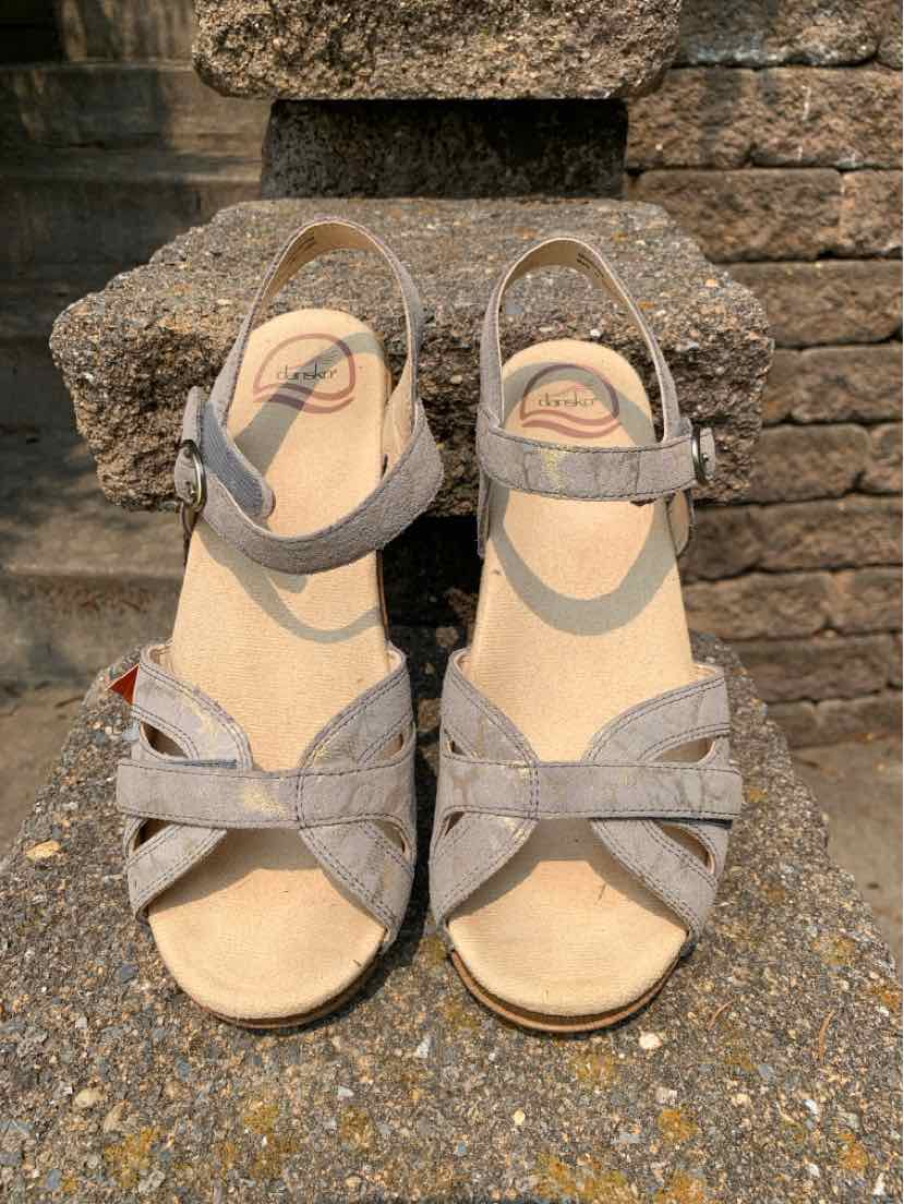 Gray suede open-toe sandals with adjustable ankle straps and cushioned beige insoles.