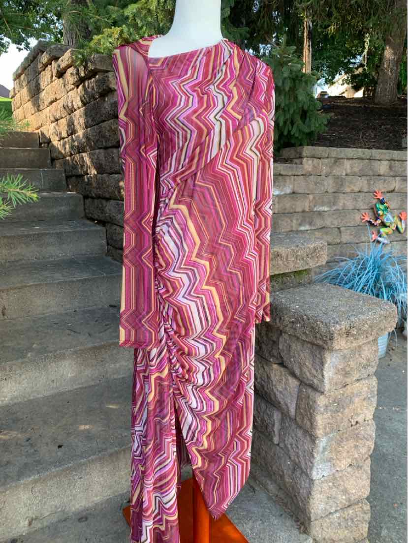 Pink and orange wavy patterned long-sleeve midi dress with ruched detail and slit on the side.