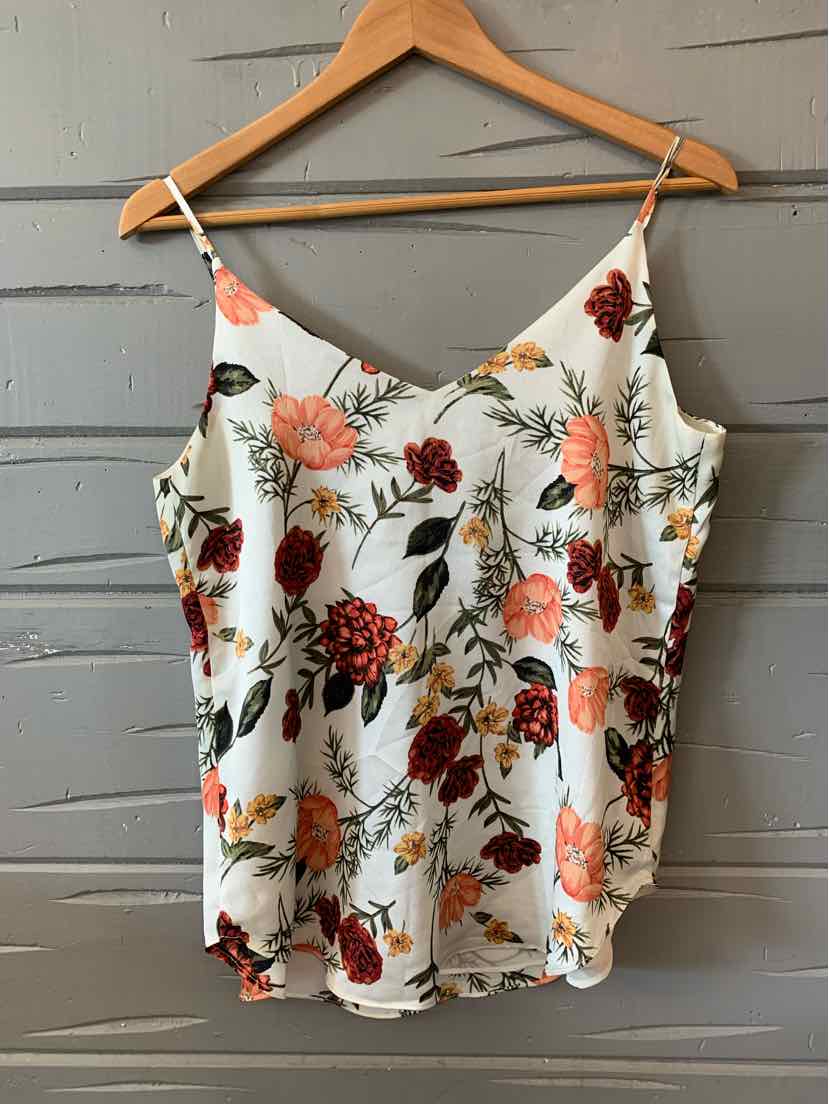 White floral sleeveless camisole with adjustable straps and red, orange, and green flower print.