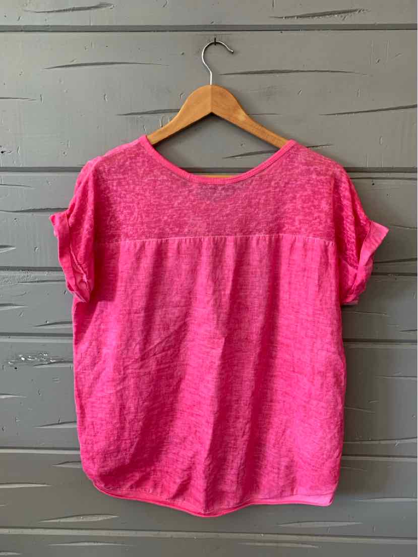Bright pink short-sleeve blouse with loose fit and gathered back detail on wooden hanger.