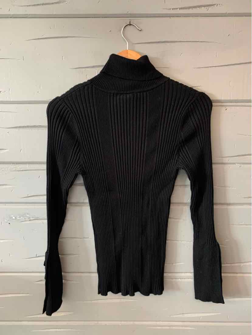 Black ribbed knit long-sleeve turtleneck sweater with fitted silhouette and slightly flared cuffs.