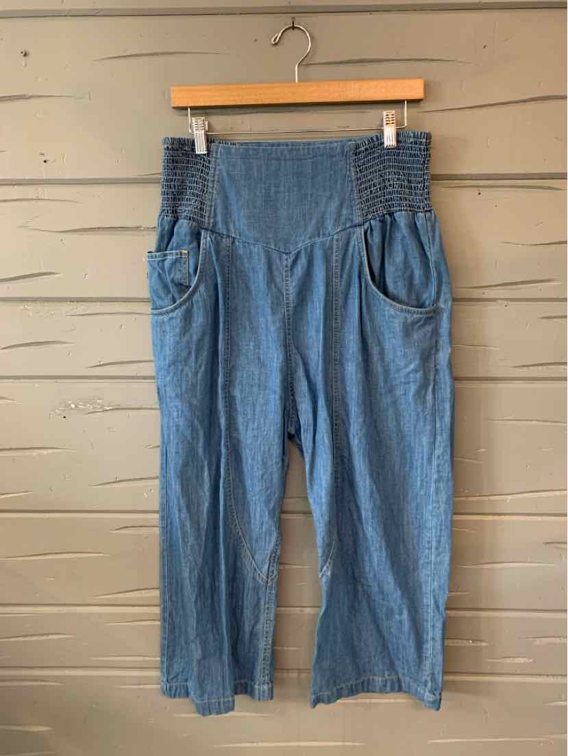 Light blue chambray wide-leg pants with high smocked waistband and front pockets.