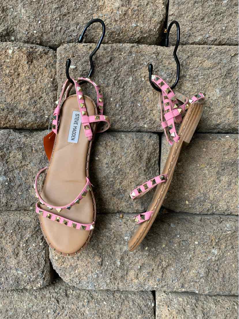 Pink studded flat sandals with ankle straps and open toes, size 8.5, wedge heels.