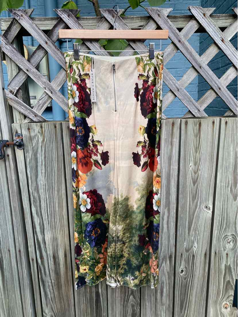 Sleeveless midi dress with floral print in red, purple, and green on white background, zipper front.
