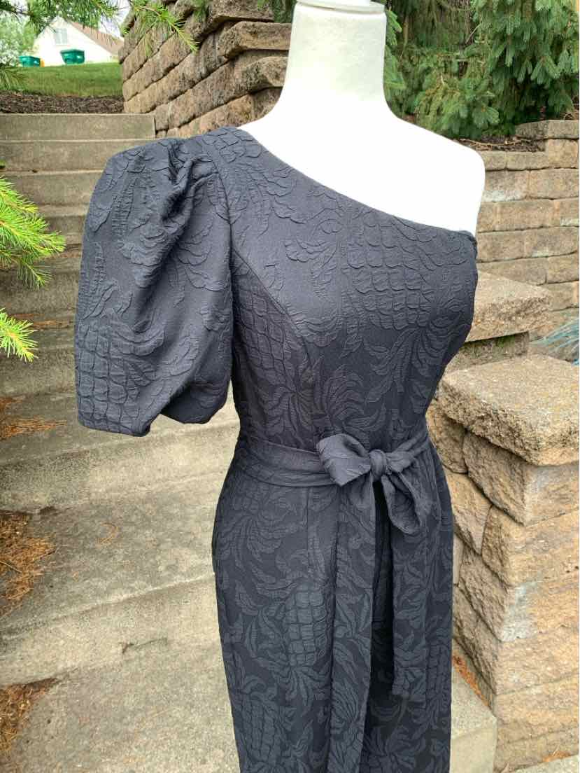 Black one-shoulder jacquard dress with puff sleeve and waist tie belt.