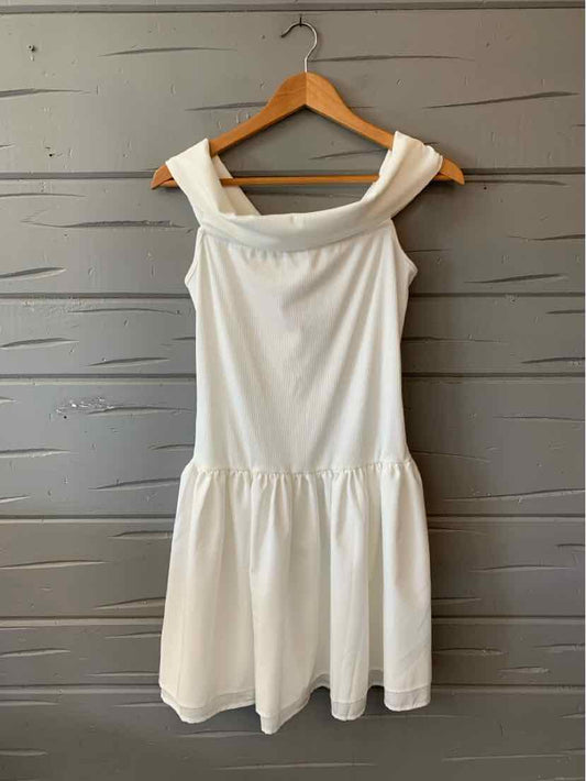 White sleeveless dress with wide straps, fitted bodice, and gathered skirt in lightweight fabric.