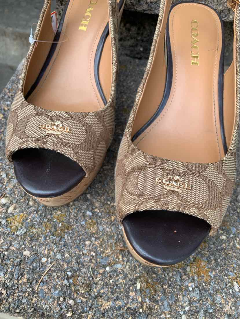 Brown Coach women's peep-toe wedge shoes with signature monogram canvas and gold logo detail, size 7.5.