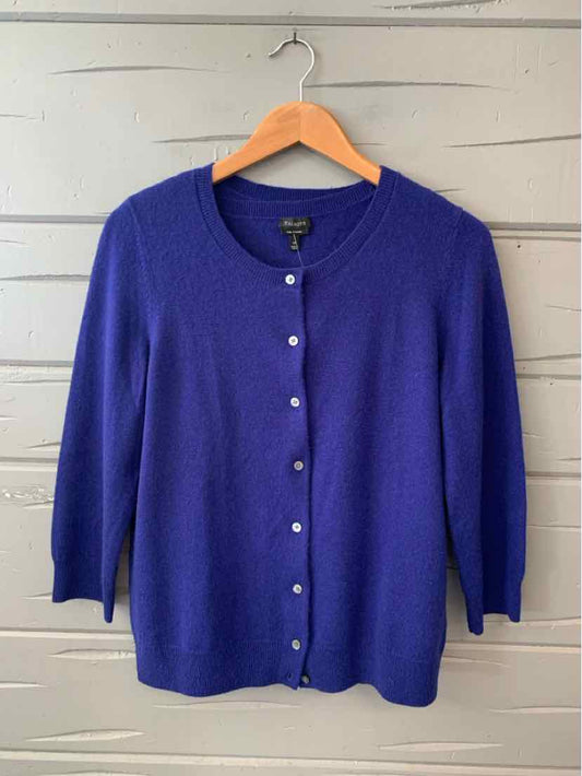 Royal blue cardigan with round neckline, long sleeves, and front pearl-like buttons.