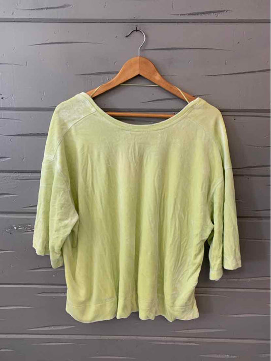 Light green loose-fit short-sleeve top with wide scoop neck, soft fabric.