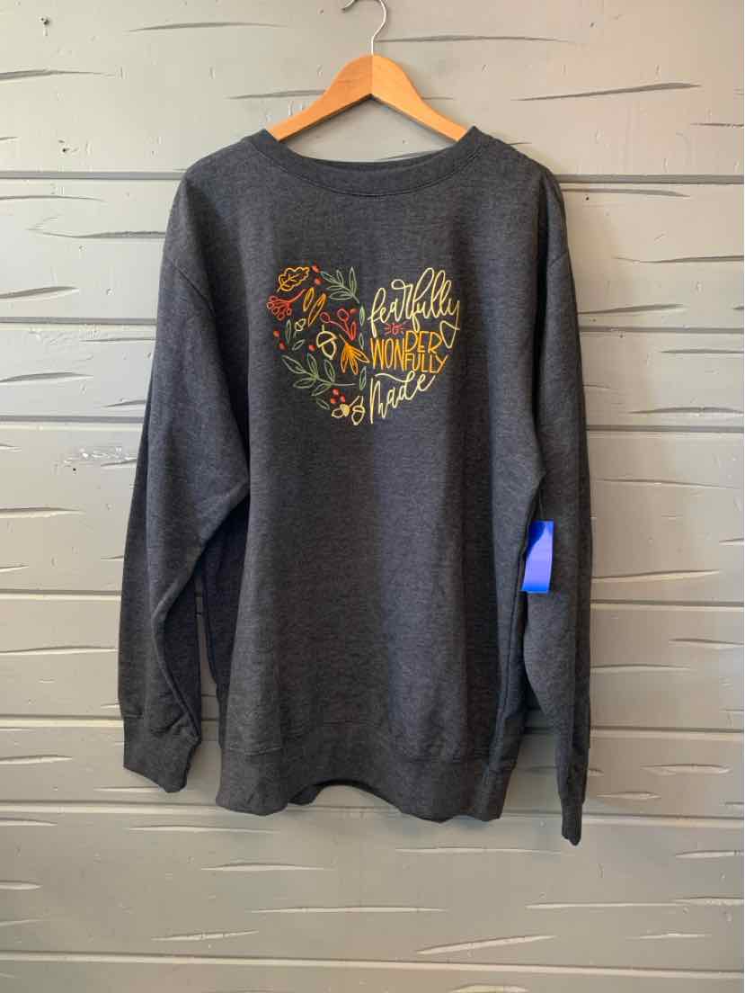 Charcoal gray long-sleeve T-shirt with a colorful floral “Love in Faith” graphic on the chest.