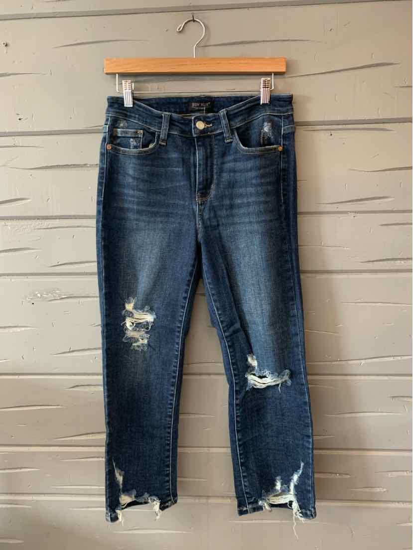 Dark blue denim jeans with distressed rips on thighs and hems, cropped length, five-pocket style.