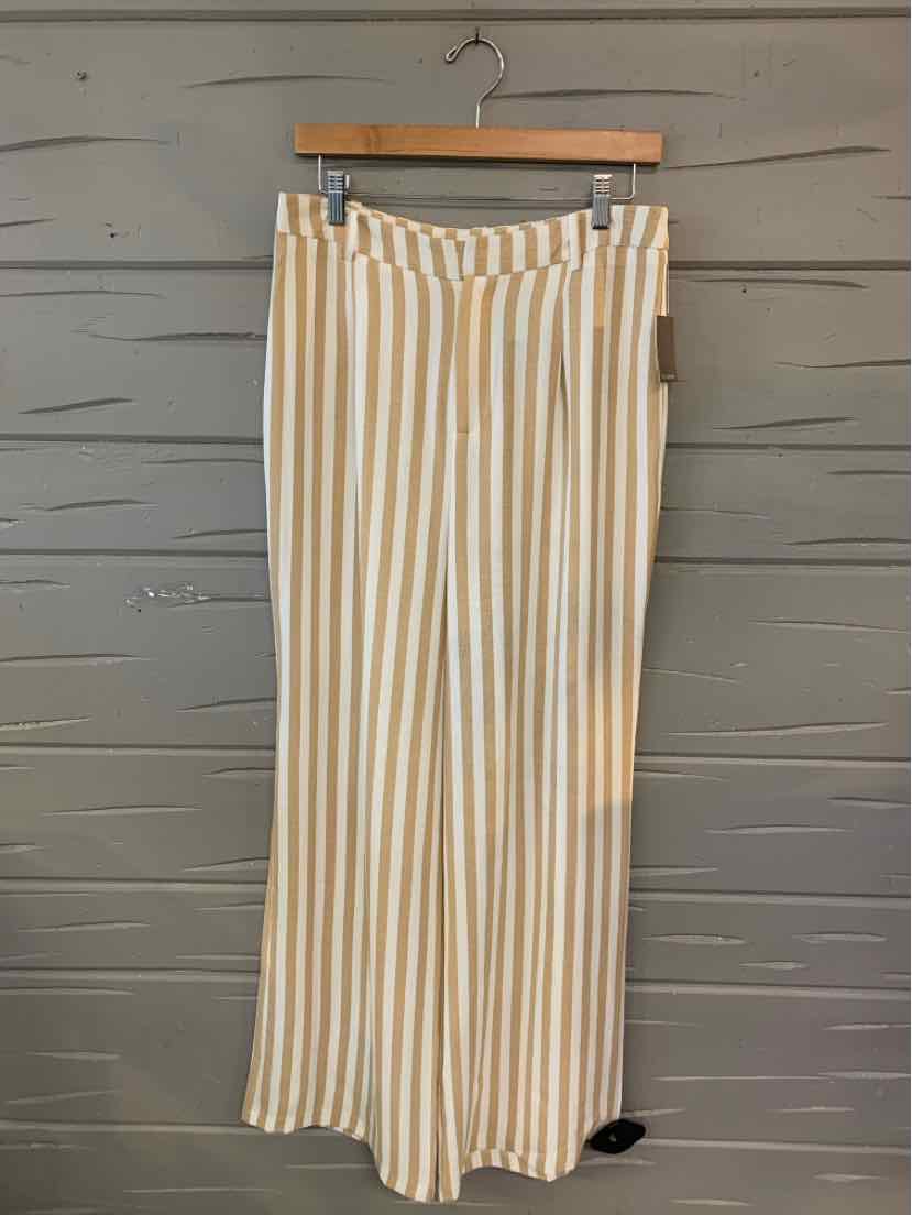 Tan and white vertical striped wide-leg pants hanging on wooden hanger.