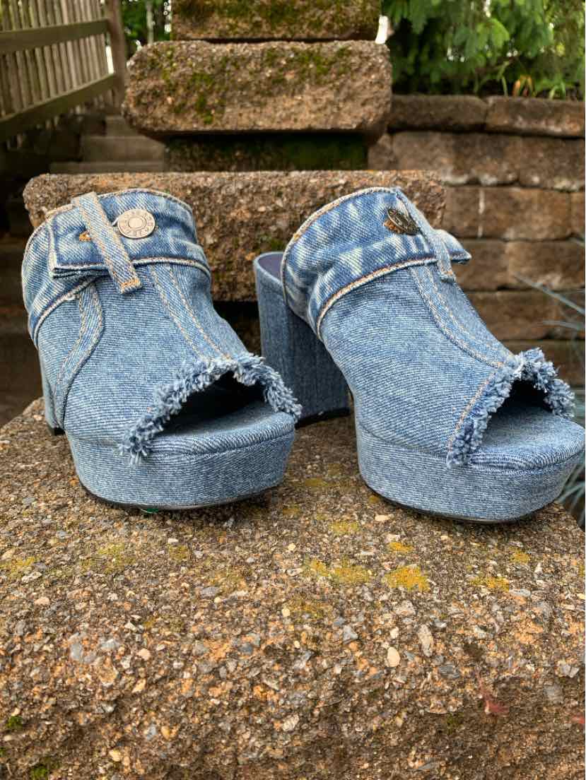 Blue denim open-toe platform shoes with ankle straps and frayed edges, size 6.